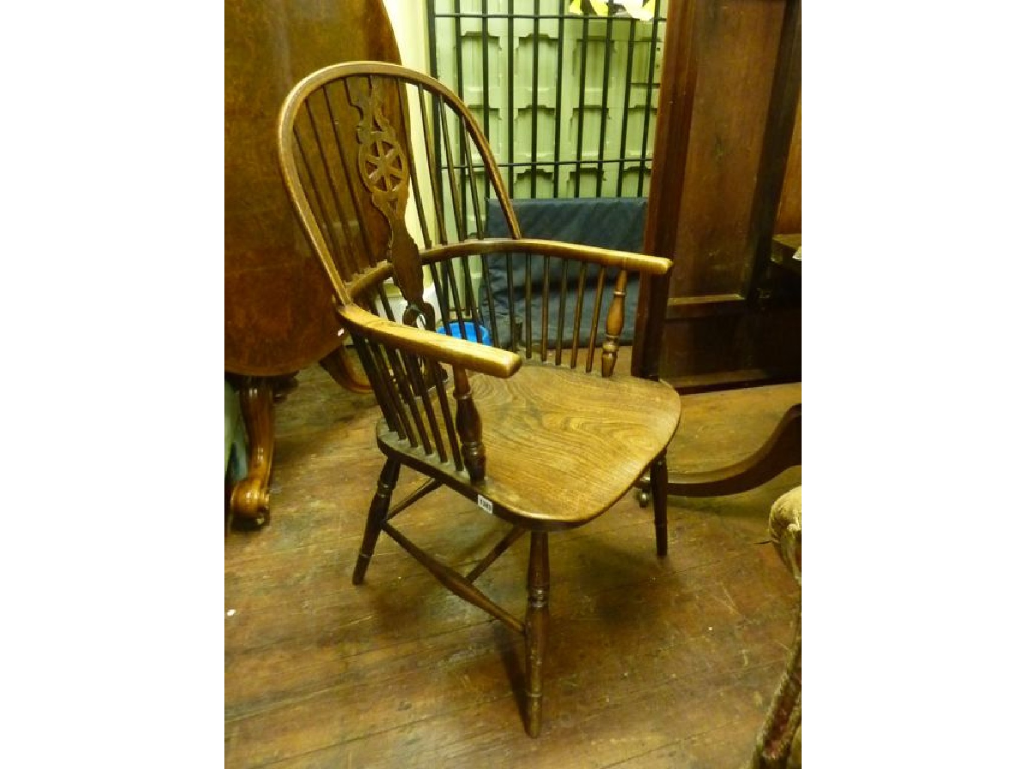 Appraisal: A late th century Windsor wheel back elbow chair in