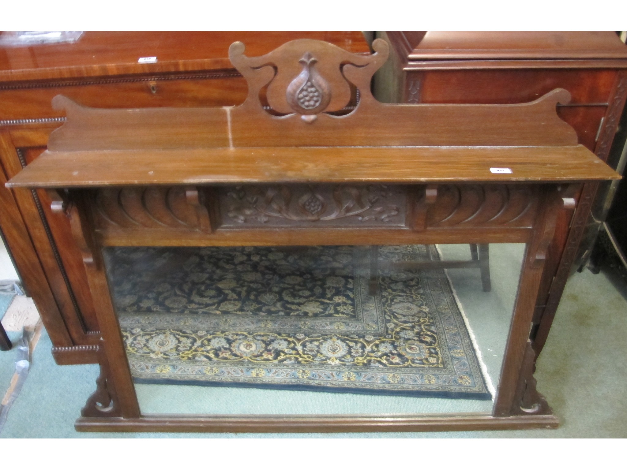 Appraisal: A carved oak over-mantle mirror