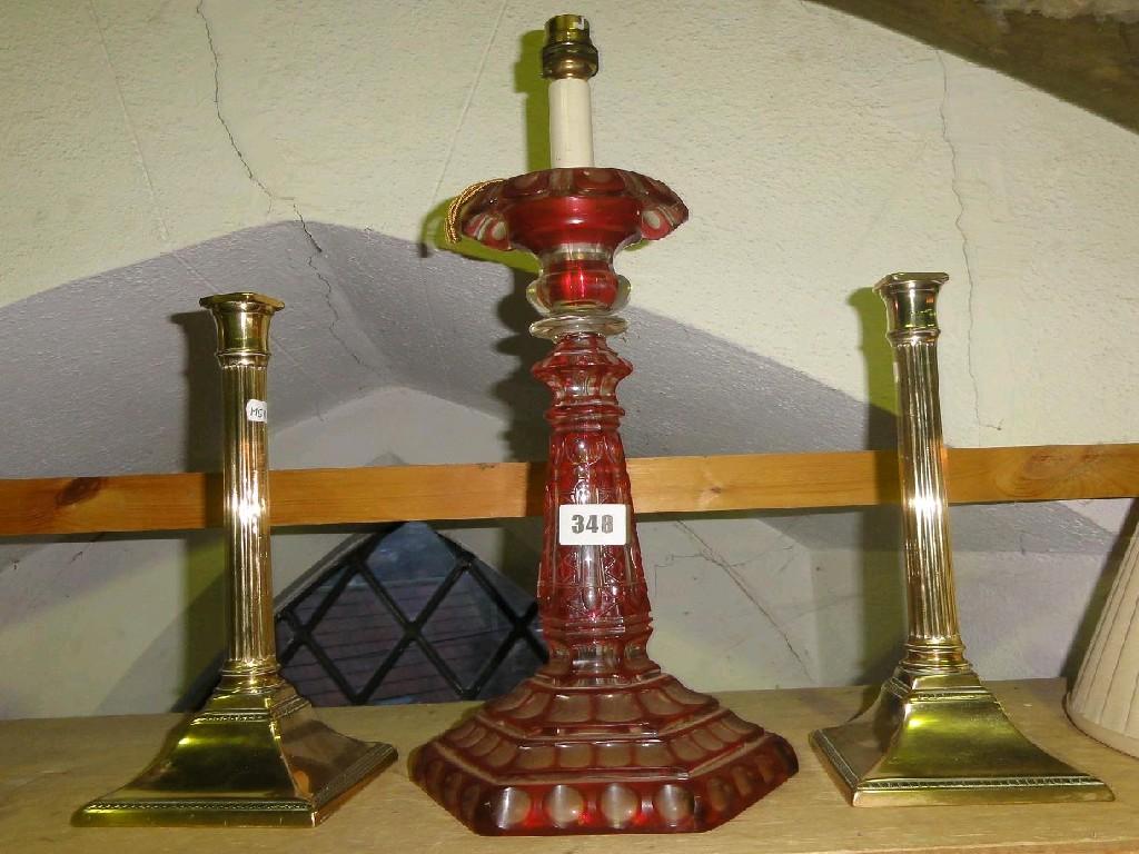 Appraisal: A cranberry glass table lamp and a pair of brass