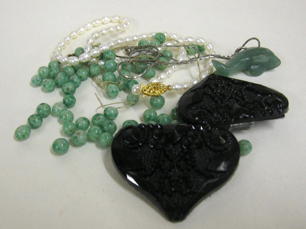 Appraisal: Lot comprising jet buckle jade beads jade dolphin pendant and