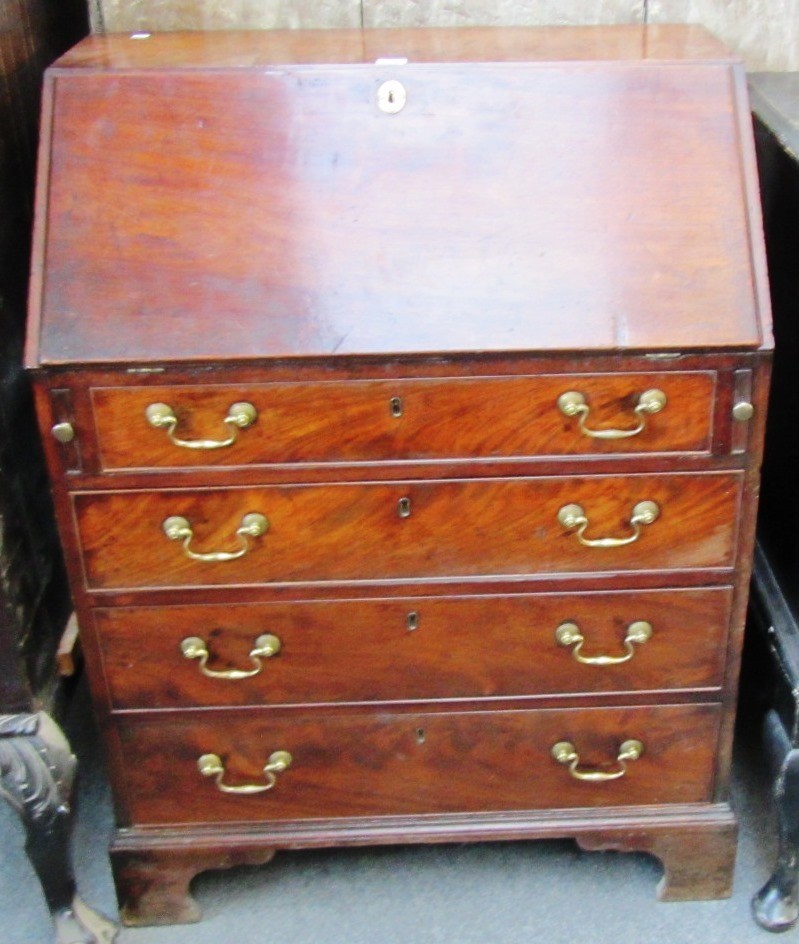 Appraisal: A George III mahogany bureau the fall enclosing a fitted