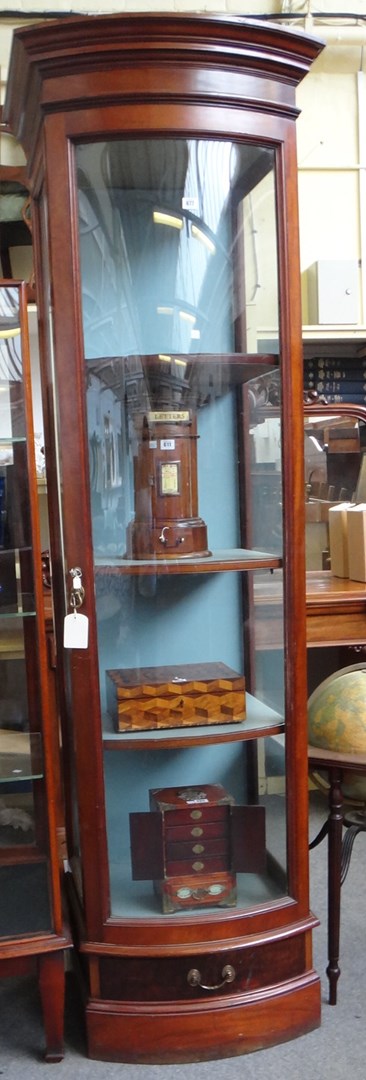 Appraisal: A large mahogany framed floor standing bowfront shop display cabinet