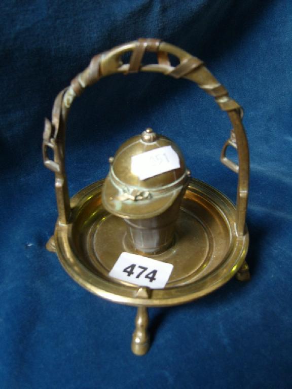 Appraisal: A brass inkwell in the form of a stirrup and