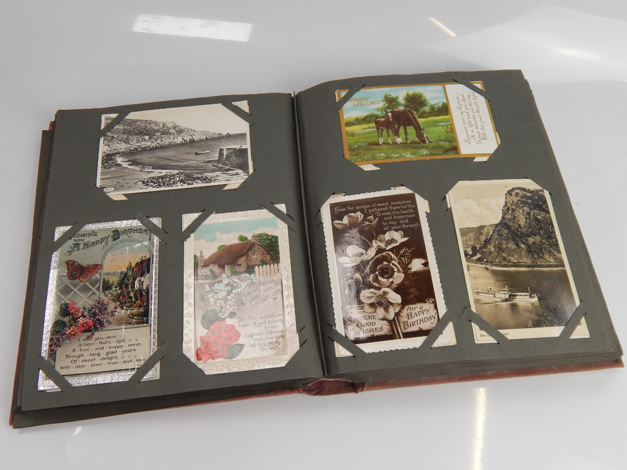 Appraisal: A postcard album containing a collection of various cards including