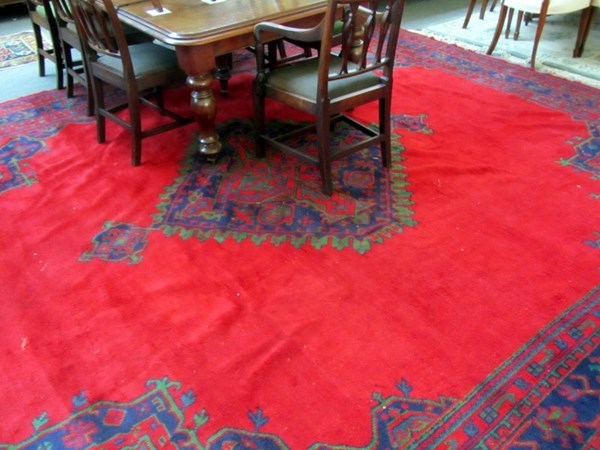 Appraisal: A Turkish carpet the plain red field with a bold