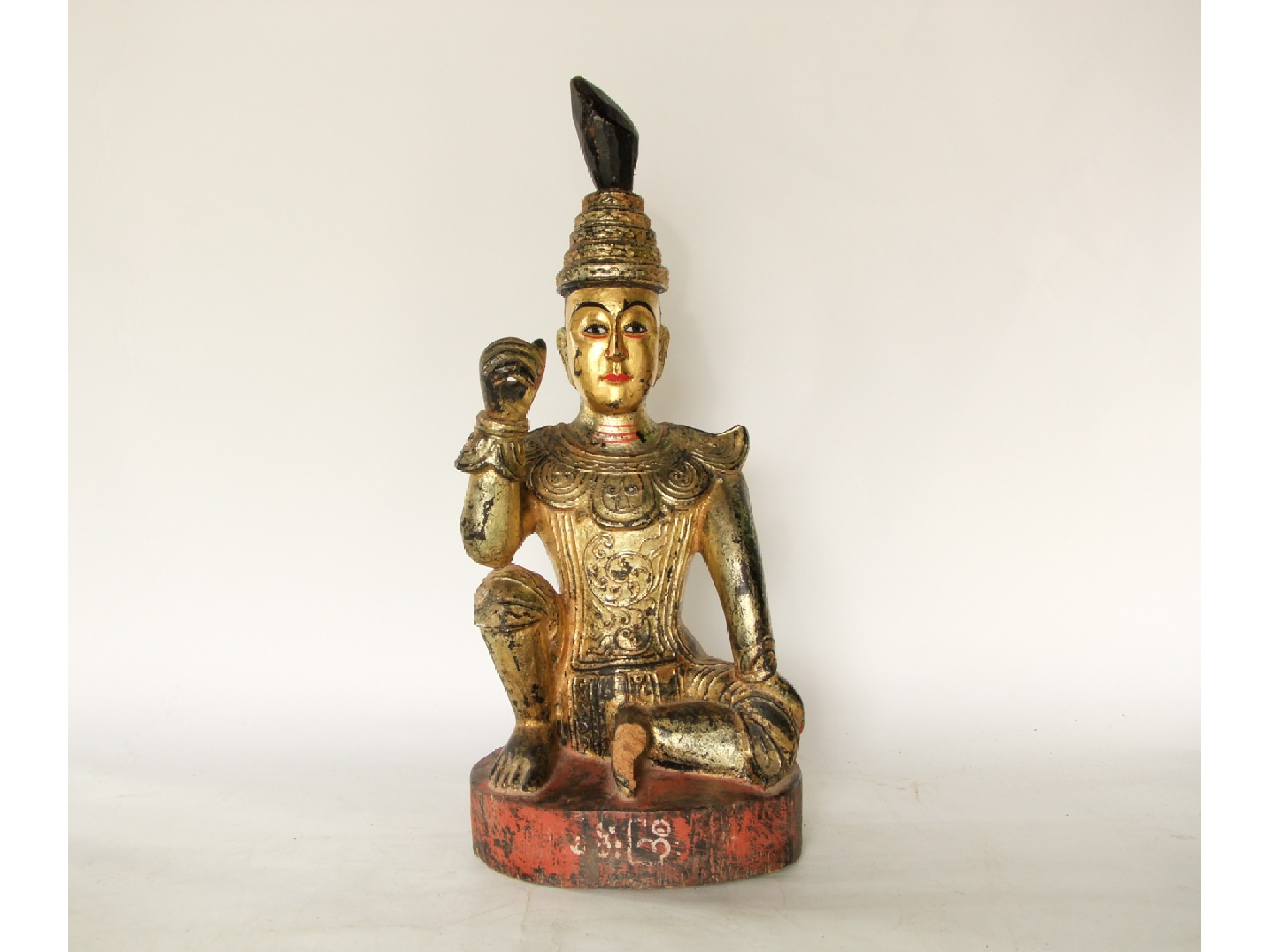 Appraisal: A carved eastern timber figure of a seated deity with