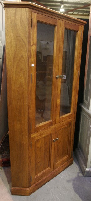 Appraisal: A teak and pine corner cupboard with glazed doors cm