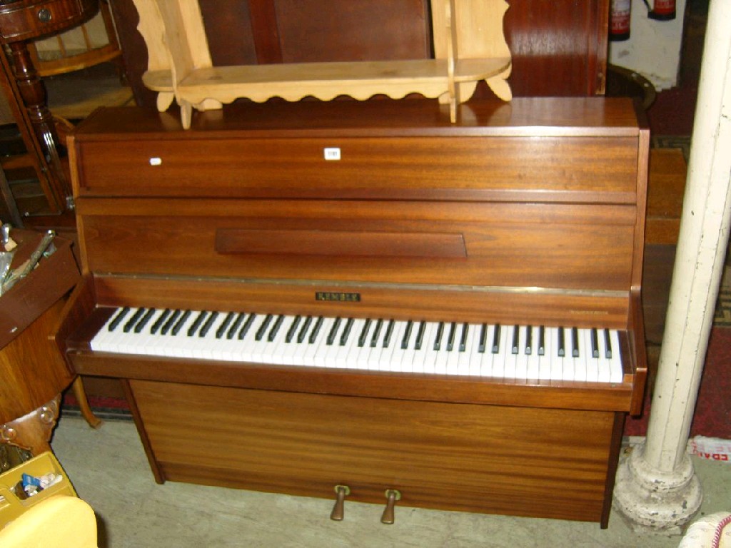 Appraisal: A modern upright iron framed and over strung piano by