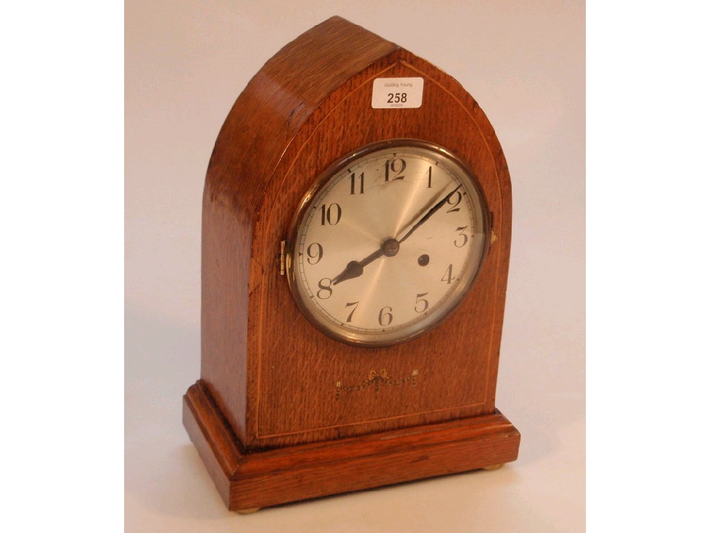 Appraisal: An Edwardian oak Lancet mantel clock with eight day movement