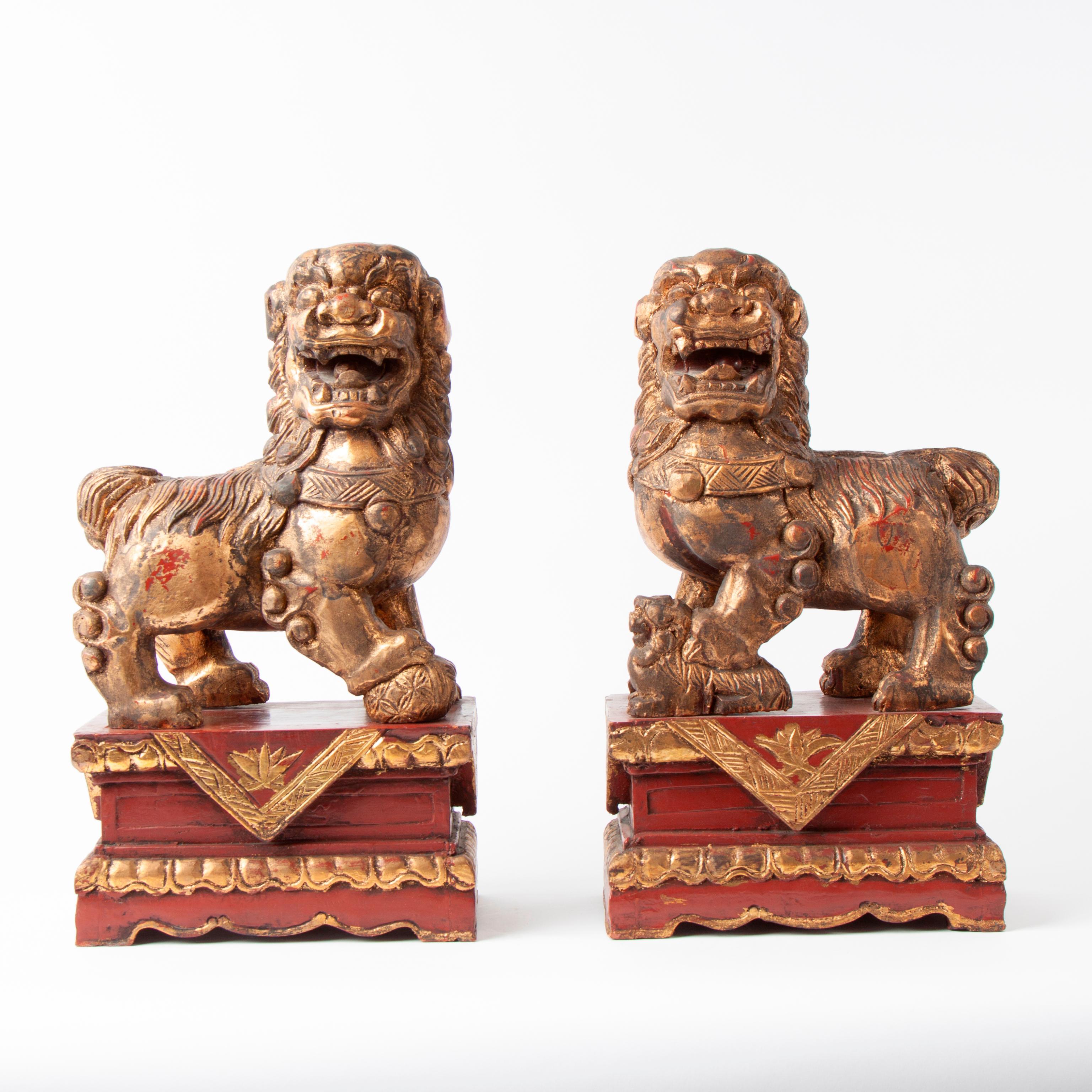 Appraisal: RED LACQUER AND GOLD LEAF FOO DOGS PAIR A pair