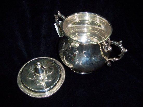 Appraisal: A two-handled porringer with C-scroll handles crested and with presentation