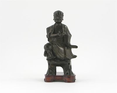 Appraisal: A Chinese bronze model of a seated lohan wearing flowing