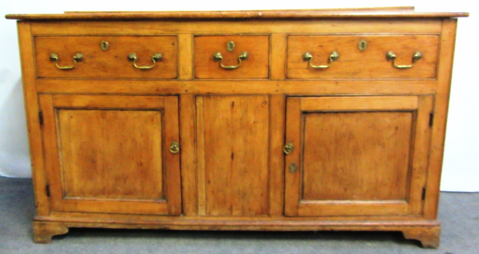 Appraisal: A George III pine dresser base with three drawers over