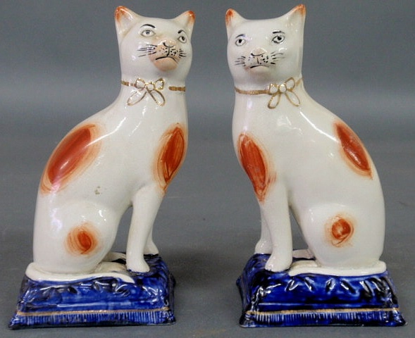 Appraisal: Pair of Staffordshire seated cats with cobalt blue bases h