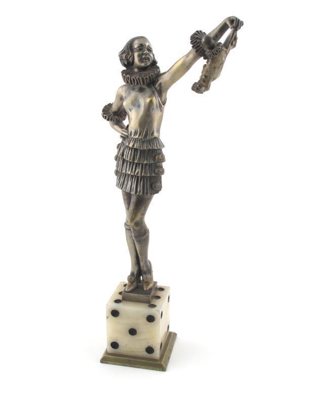 Appraisal: Girl on a Dice holding a Pierrot doll a patinated