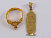 Appraisal: A yellow metal tests carat gold pendant and a similar