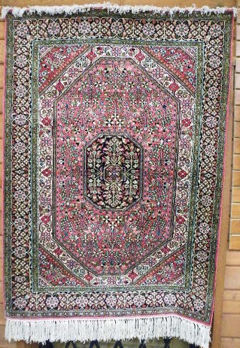 Appraisal: SILK AREA RUG Persian Qum design floral and central flower-filled