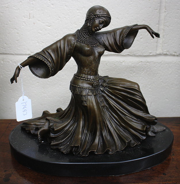 Appraisal: A BRONZE SCULPTURE OF A DANCING GIRL in a semi