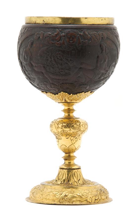 Appraisal: Carved Coconut and Gilt Metal Mounted Chalice the cup depicting