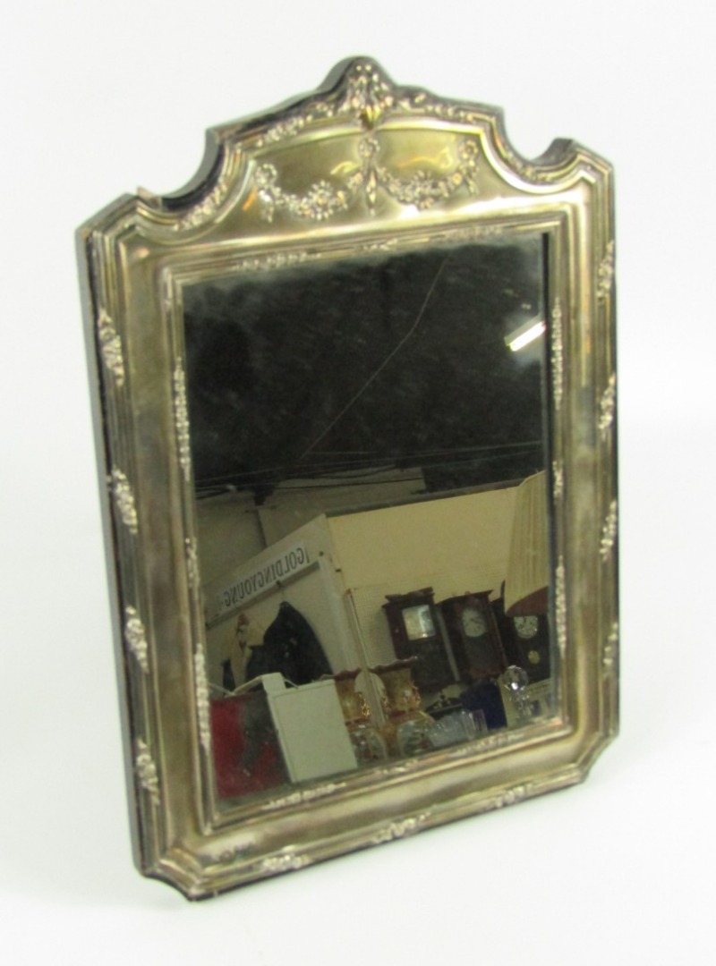 Appraisal: A Geo V silver table mirror with broken arched top