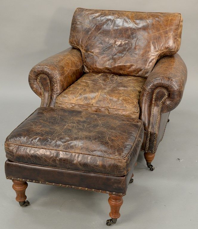 Appraisal: Leather upholstered chair and ottoman ht in wd in Leather