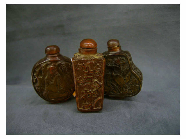 Appraisal: Three carved antique oriental amber snuff bottles one depicting crane