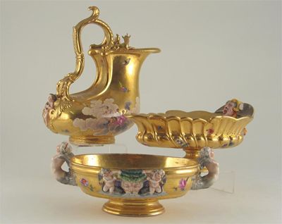 Appraisal: A Continental porcelain gilt ewer applied with a cherub and