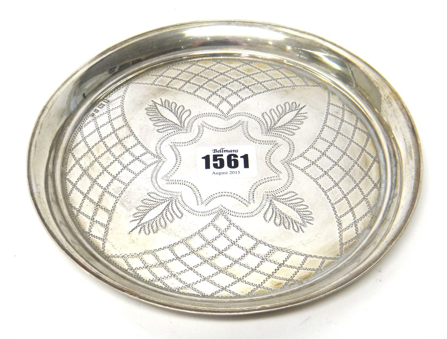 Appraisal: A silver circular small tray with engraved decoration diameter cm