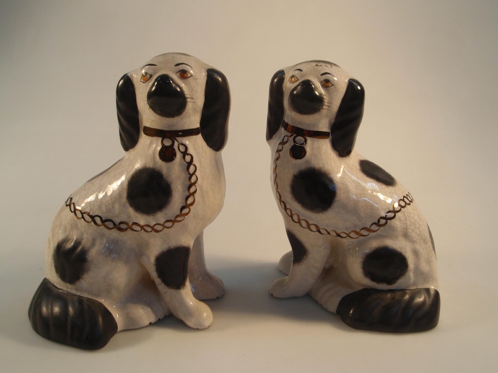 Appraisal: A pair of late thC Staffordshire pottery spaniels with orange