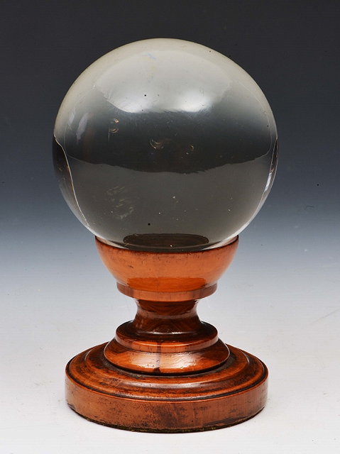 Appraisal: A MOULDED GLASS SPHERE on a turned wooden stand cm