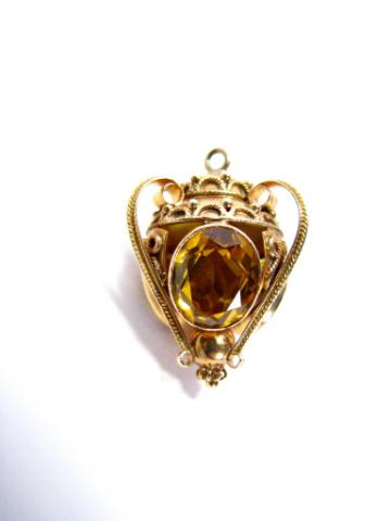 Appraisal: Yellow gold citrine pendant in ornate scroll swag and bead