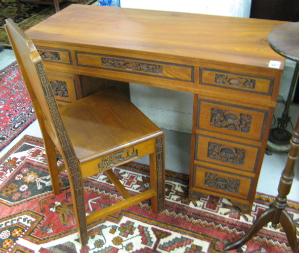 Appraisal: CARVED TEAKWOOD WRITING DESK AND CHAIR Chinese mid th century