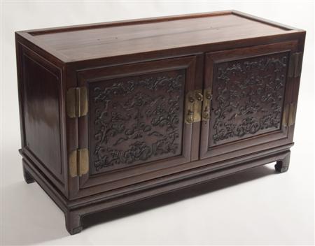 Appraisal: A Chinese hardwood cabinet on stand of rectangular form with