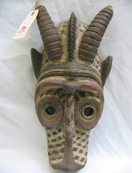 Appraisal: AN AFRICAN HAND CARVED WOODEN MASK round eyes open-toothed mouth