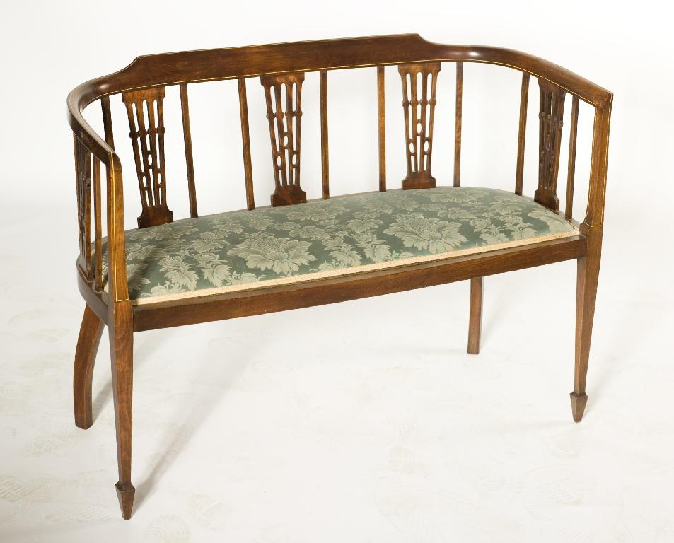 Appraisal: ELEGANT EDWARDIAN INLAID MAHOGANY DRAWING ROOM SETTLE the curved one-piece