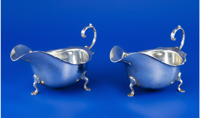 Appraisal: A Pair Of Large Silver Gravy Boats Raised On Feet