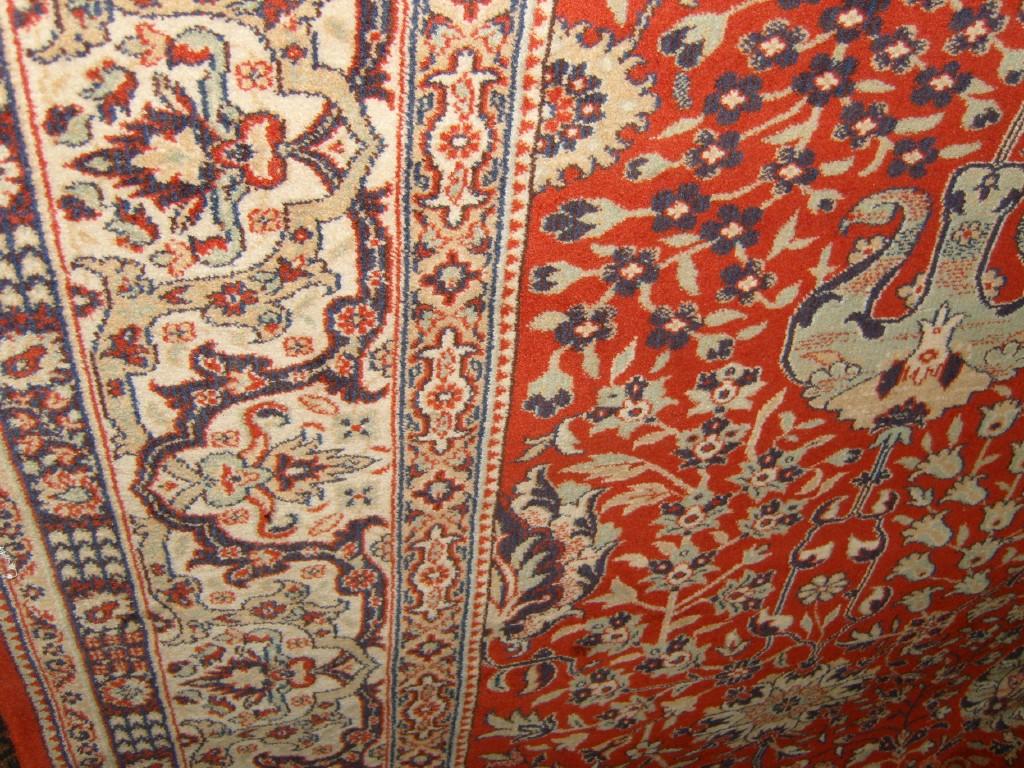 Appraisal: A large red ground wool carpet in the Persian style