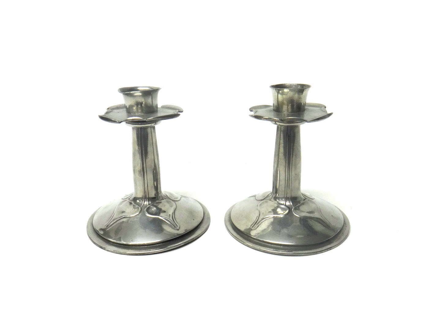 Appraisal: A pair of Liberty Co pewter candlesticks each with relief