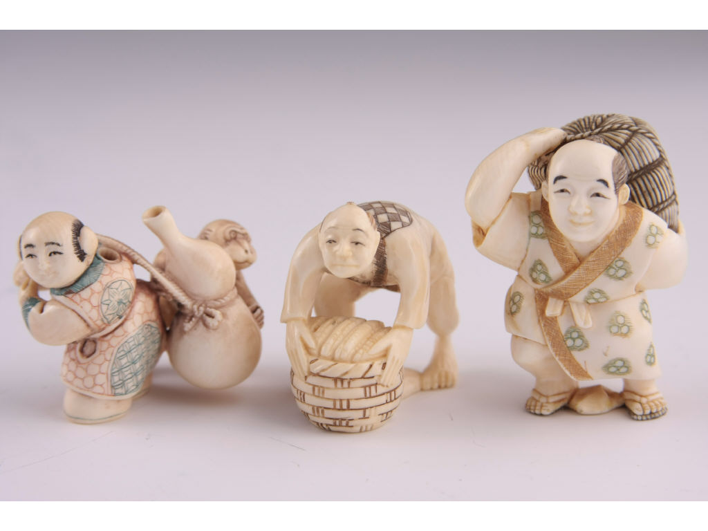 Appraisal: Three Netsuke Katabori Ivory group of three laborers late period