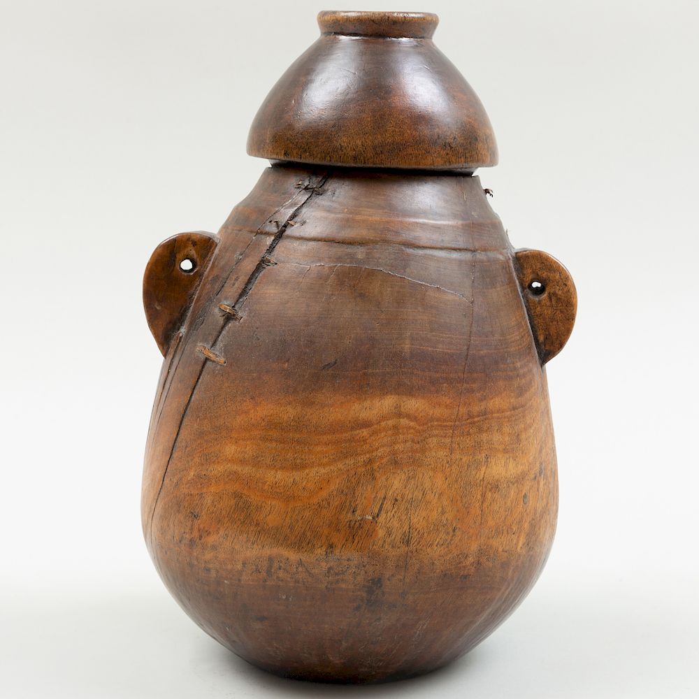 Appraisal: East African Carved Wood Milk Container Carved with two handles