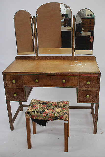 Appraisal: AN ART DECO LIMED OAK DRESSING TABLE with three glass