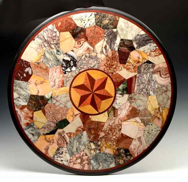 Appraisal: A SPECIMEN MARBLE CIRCULAR TABLE TOP with central star motif