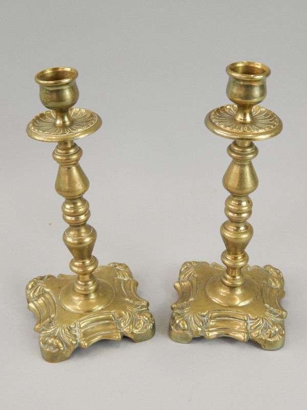 Appraisal: A pair of thC cast brass candlesticks each with a