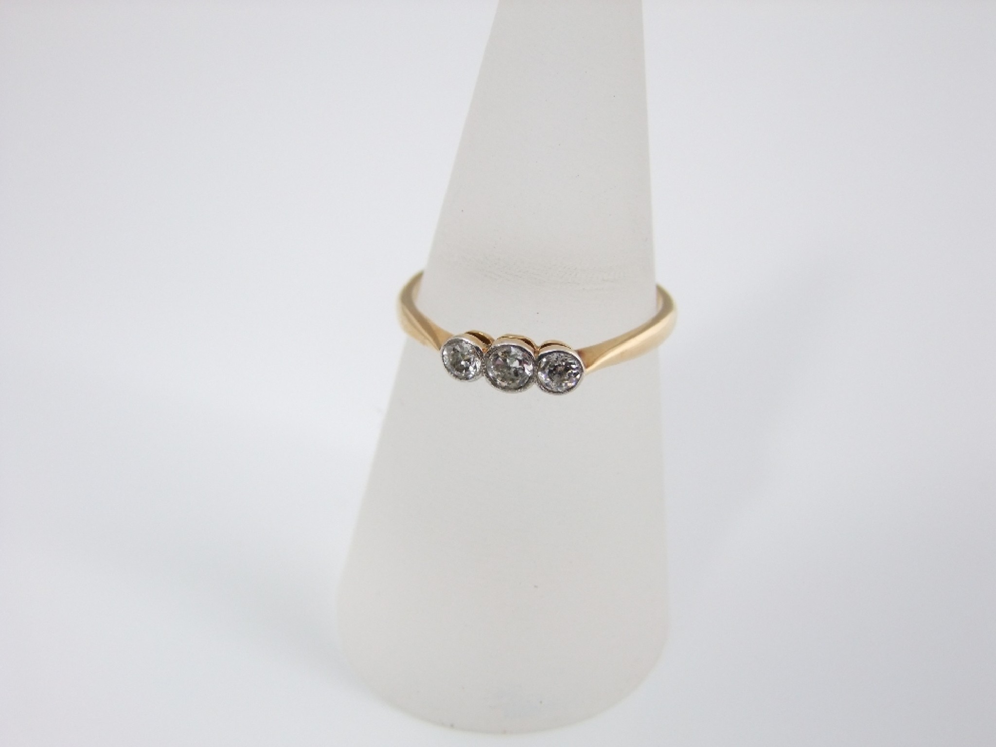 Appraisal: An ct gold and platinum set three stone diamond ring