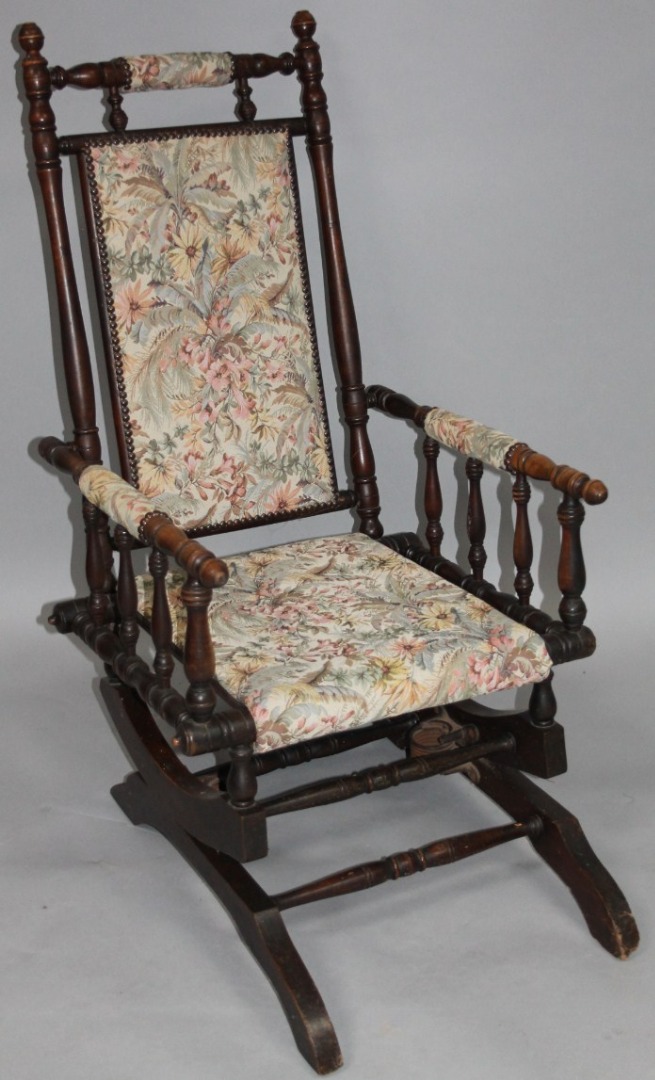 Appraisal: An early thC stained walnut American style rocking chair with