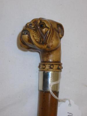 Appraisal: A WALKING STICK the stained wood grip carved as a