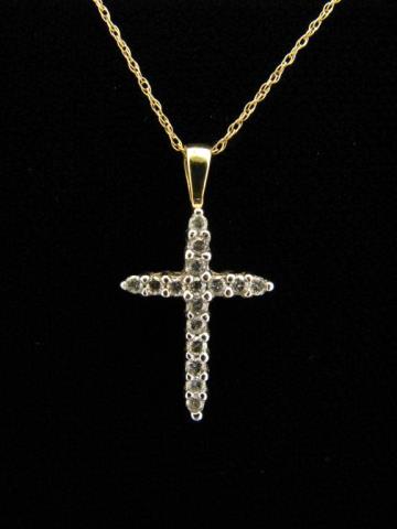 Appraisal: A K yellow gold cross pendant with sixteen round diamonds