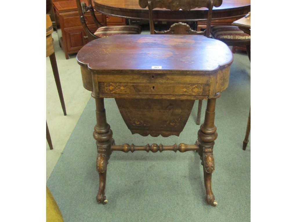 Appraisal: A Victorian walnut marquetry inlaid sewing table raised on turned