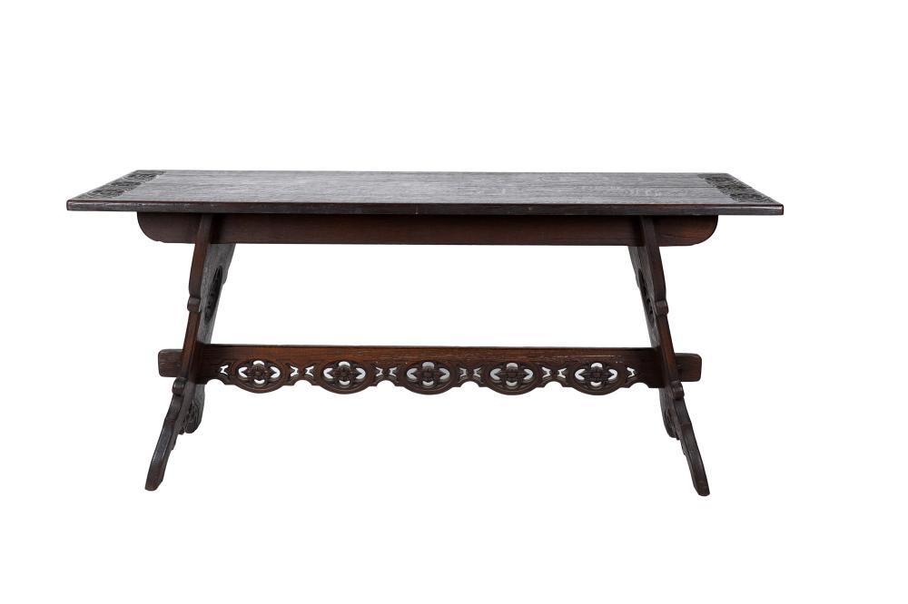 Appraisal: CARVED OAK TRESTLE TABLEthe rectangular top with relief-carved floral motifs