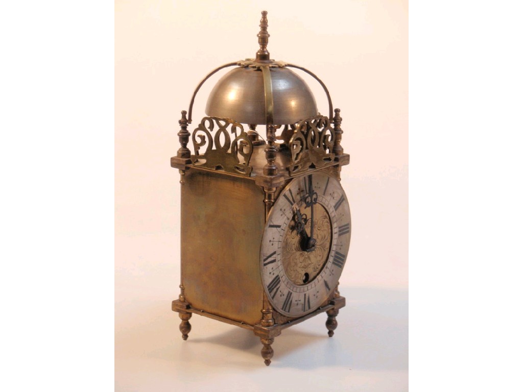 Appraisal: A brass framed lantern table clock with Coventry astral movement